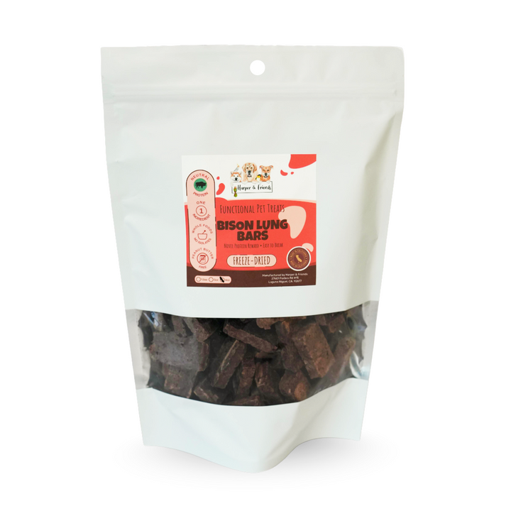A stand-up pouch of dog treats on a white background. The package is white with a clear window showing dark brown rectangular treats inside.
