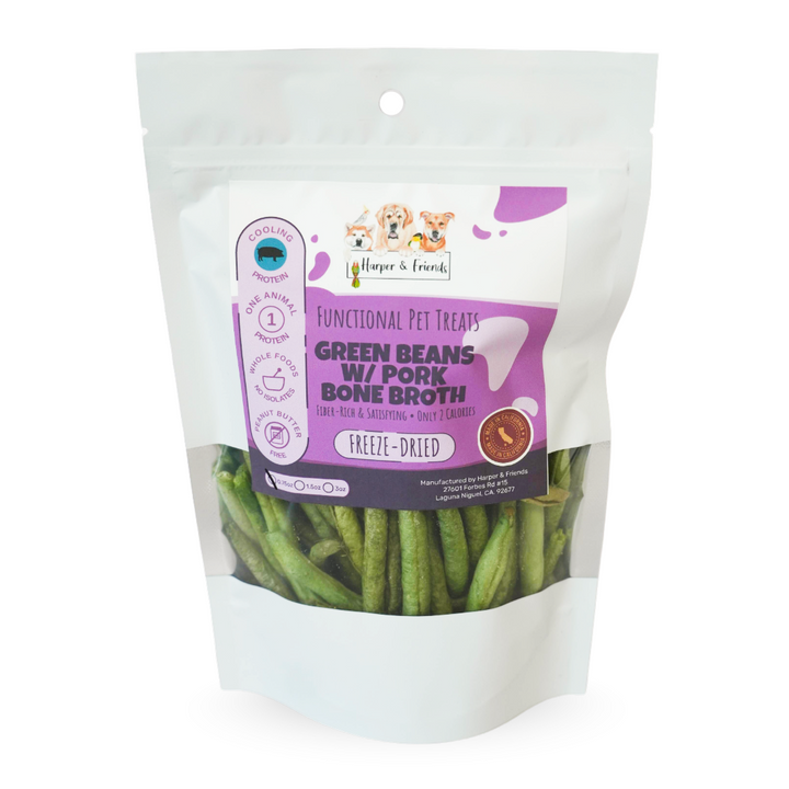 A stand-up pouch of Harper &amp; Friends Green Beans w/ Pork Bone Broth freeze-dried pet treats, showing the green beans through a clear window in a white resealable bag with a purple label.