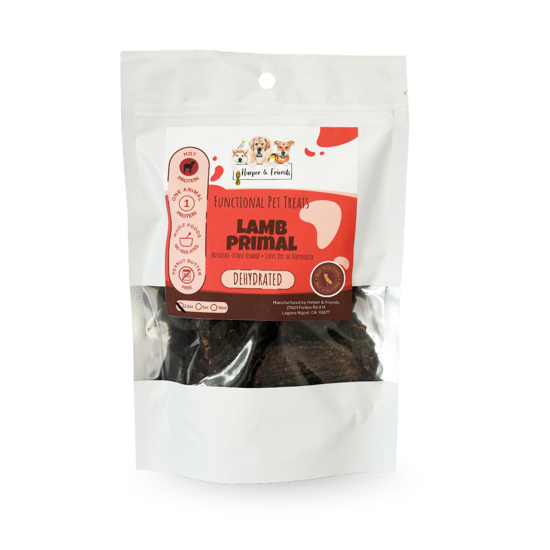 A package of functional pet treats, specifically Lamb Primal, in a white stand-up pouch with a clear window showing the dark brown treats inside.