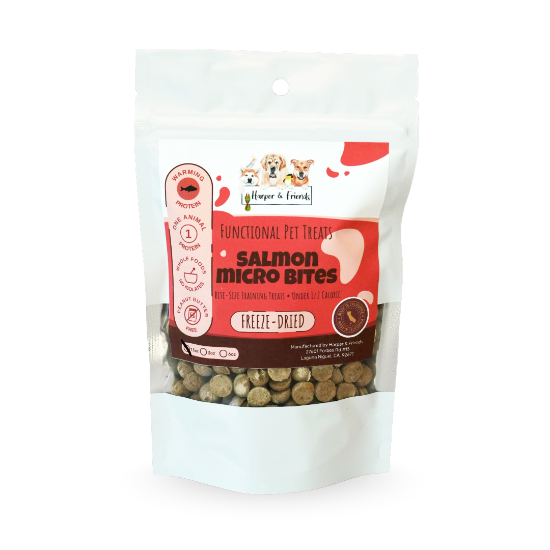 A stand-up pouch of Harper &amp; Friends Salmon Micro Bites freeze-dried pet treats, featuring a white and orange label with a clear window showing the freeze-dried round shaped treats inside.