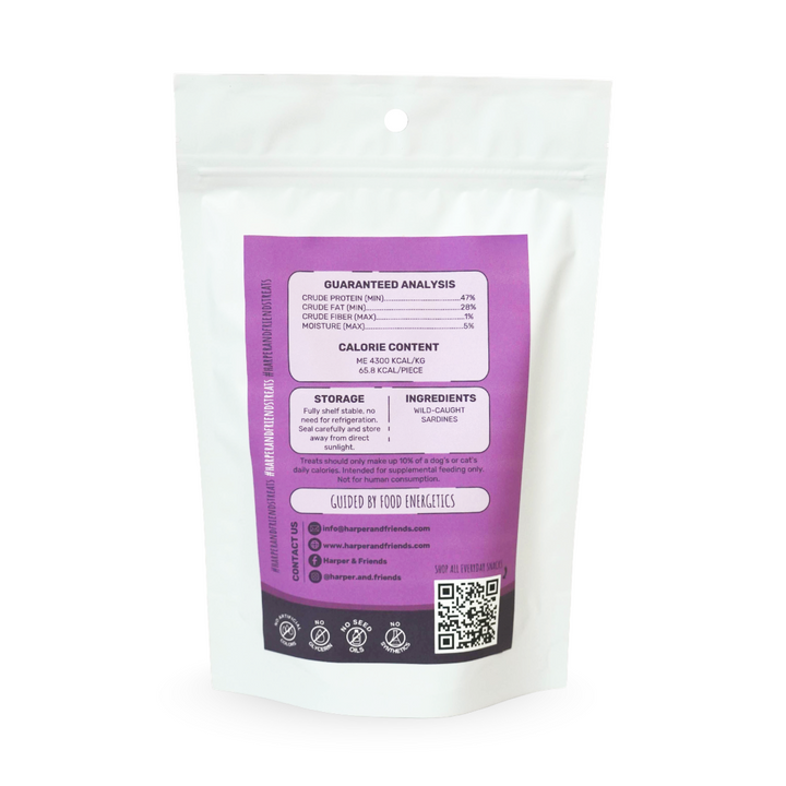 A white stand-up pouch of sardines with a large purple label showing nutritional information, ingredients, and a QR code, photographed on a white background.